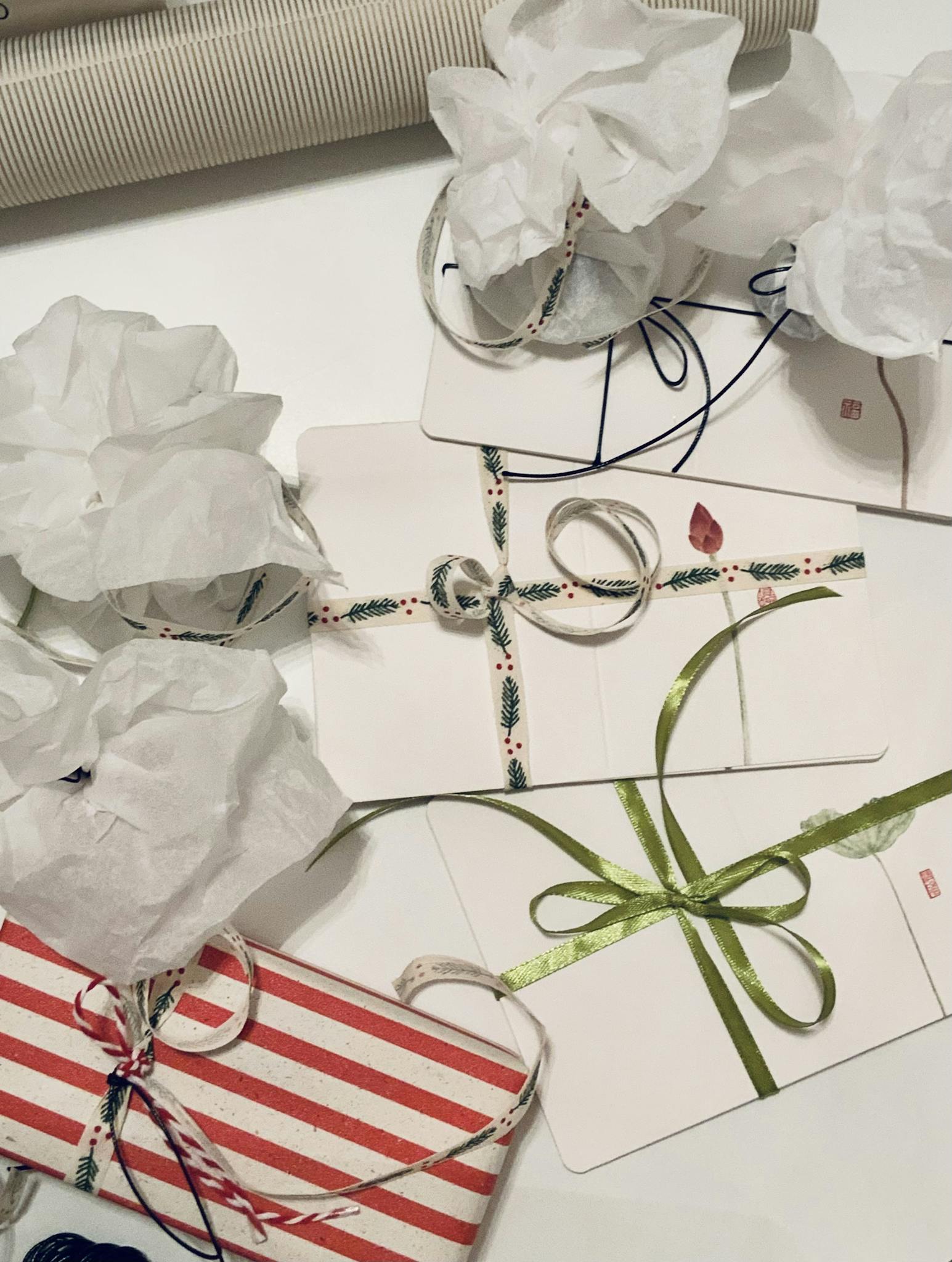 Beautifully wrapped gifts with decorative ribbons and tissue paper for festive celebrations.